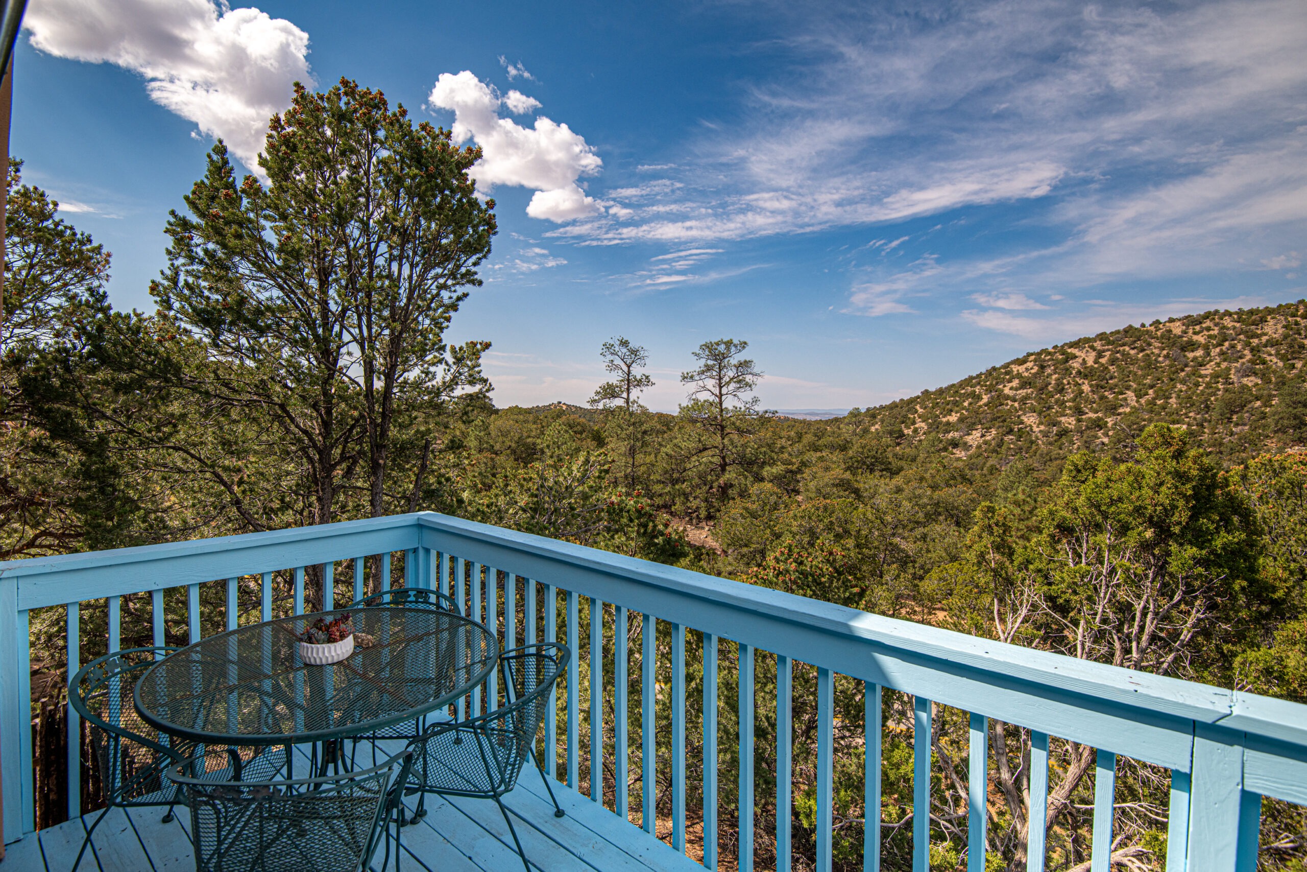 Wooden color blue balcony with table and chairs